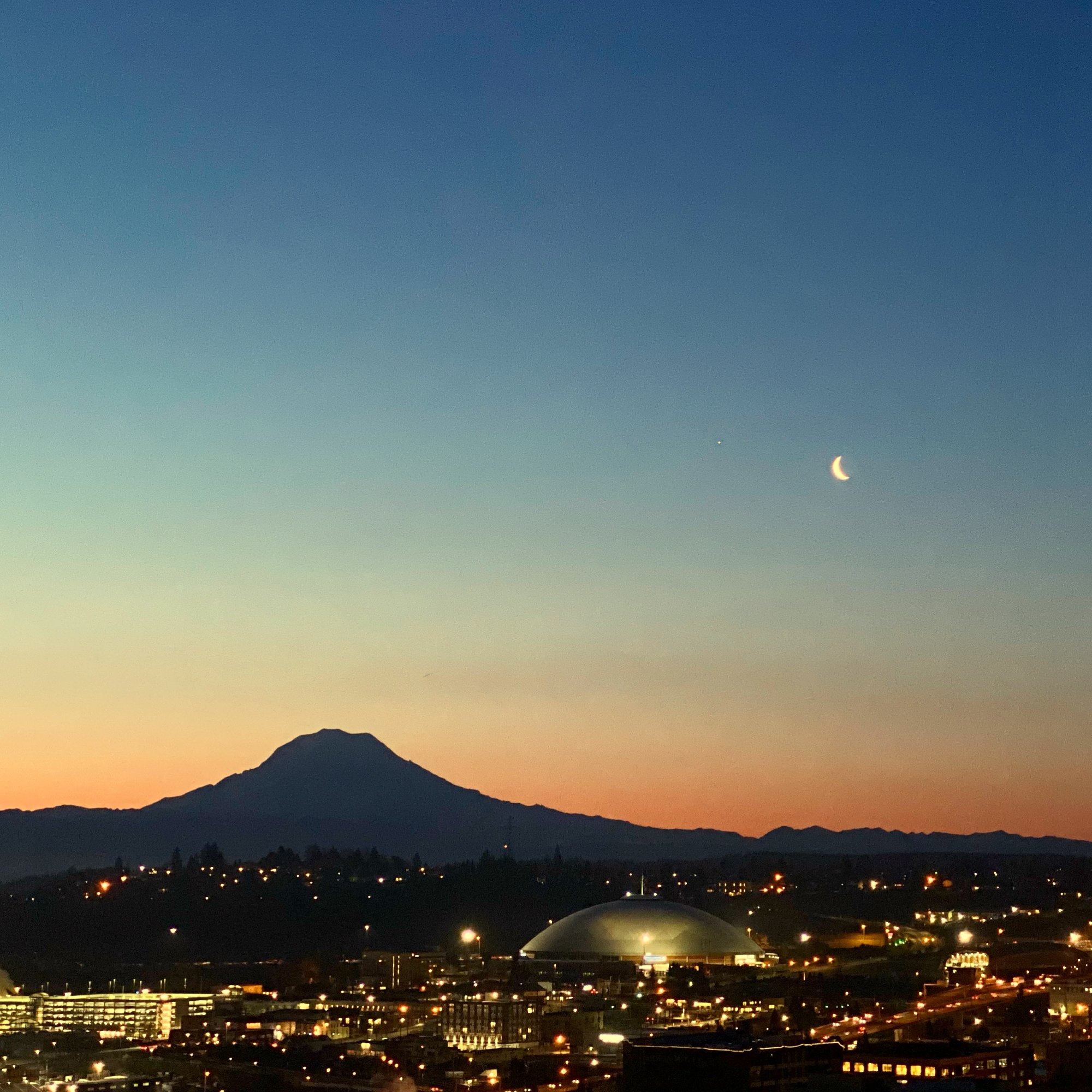 Crescent moon over Tacoma at night