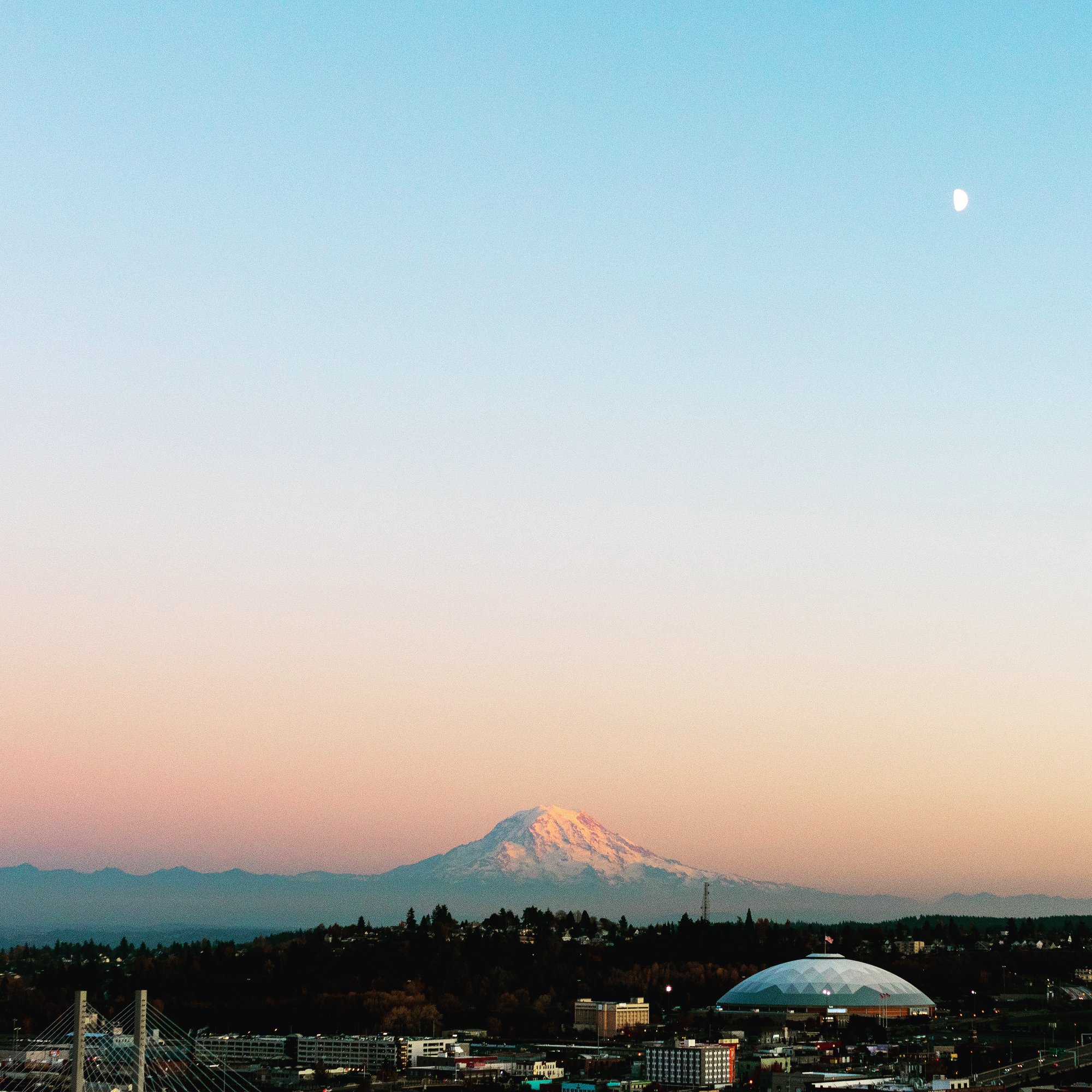 Mt. Rainier at dusk with crescent moon and Tacoma Dome